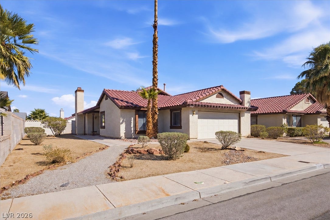 3960 Grapefruit Circle, Las Vegas, NV 89103 Classic tile roof and stucco siding define this single-level home with an attached garage.