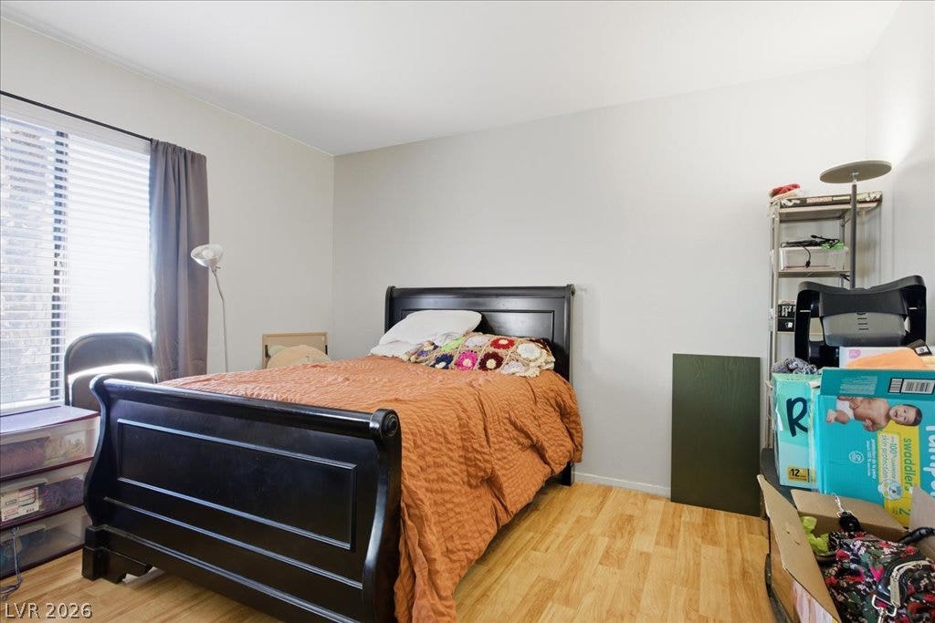3960 Grapefruit Circle, Las Vegas, NV 89103 Gleaming hardwood floors and a large window define this comfortable bedroom space.