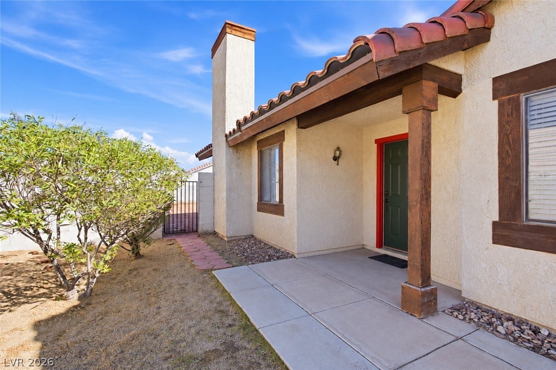 3960 Grapefruit Circle, Las Vegas, NV 89103 A welcoming front porch with classic stucco siding and Spanish tile roof accents.