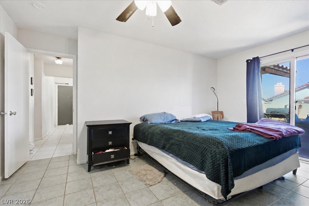 3960 Grapefruit Circle, Las Vegas, NV 89103 Sliding glass doors open directly to the outdoor patio from this tile-floored bedroom.