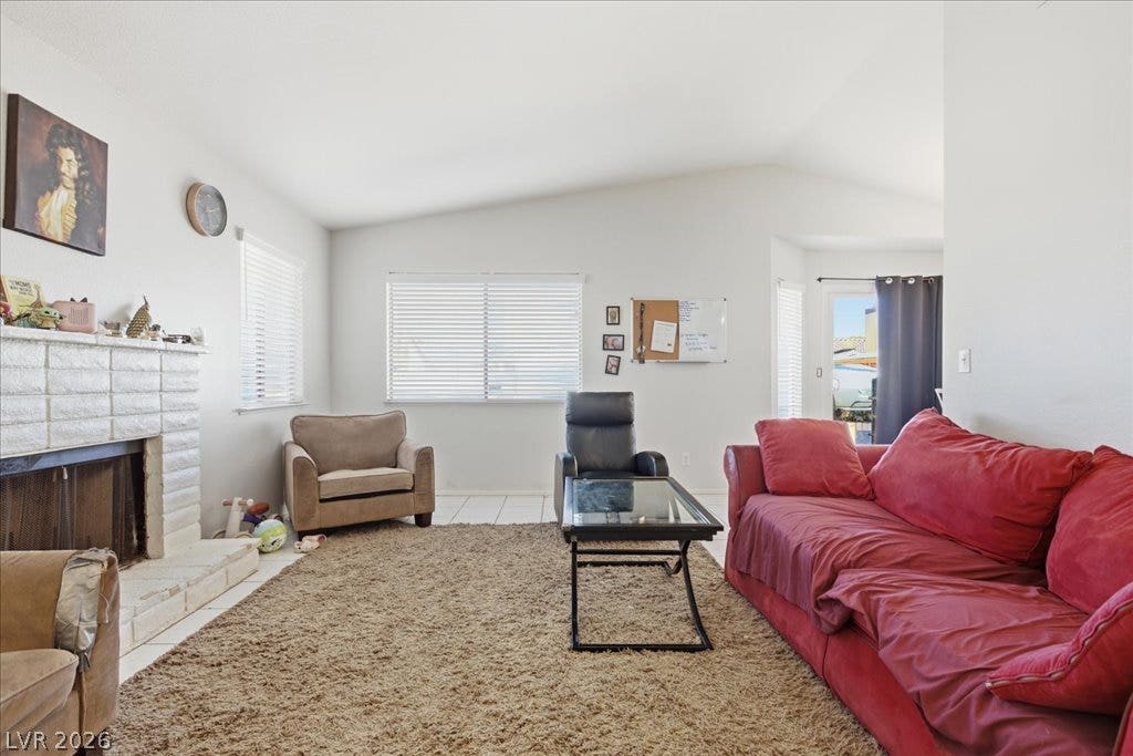 3960 Grapefruit Circle, Las Vegas, NV 89103 Vaulted ceilings and a brick fireplace create a cozy foundation in this inviting living space.