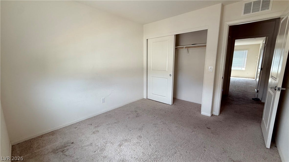 10079 Vibrant Moon Avenue, Las Vegas, NV 89129 Soft carpeting underfoot defines this versatile secondary bedroom featuring a built-in closet with sliding doors.