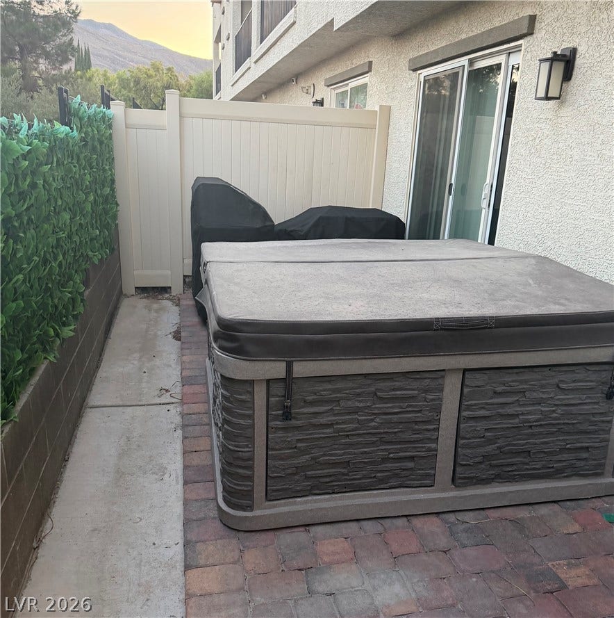 10079 Vibrant Moon Avenue, Las Vegas, NV 89129 An inviting private spa area with a stone-look hot tub, perfect for unwinding outdoors.