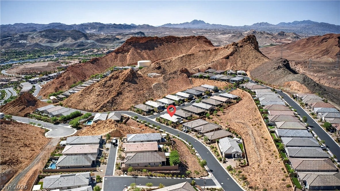 4 Bobado Lane, Henderson, NV 89011 Dramatic mountain ridges frame this elevated residential neighborhood nestled within a desert landscape.
