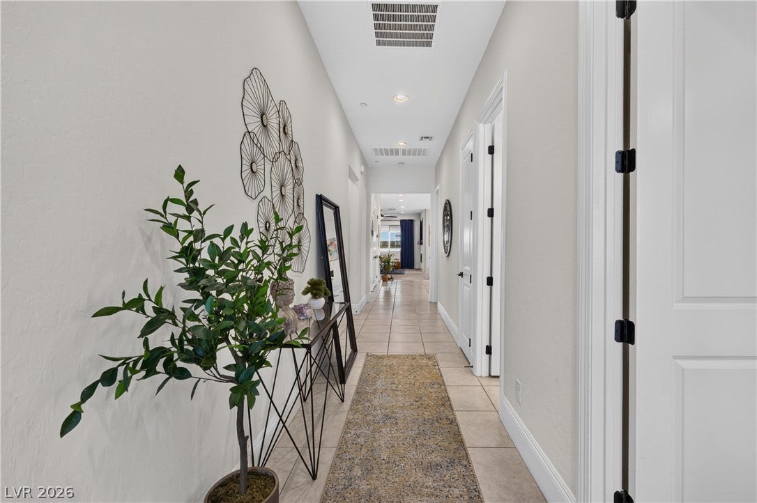 4 Bobado Lane, Henderson, NV 89011 Tiled flooring and recessed lighting line this welcoming hallway leading toward the living spaces.