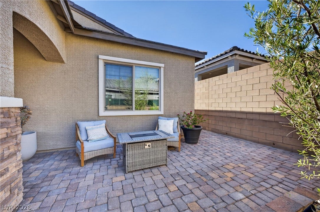 4 Bobado Lane, Henderson, NV 89011 An inviting paver courtyard provides a peaceful outdoor retreat alongside the stucco exterior.