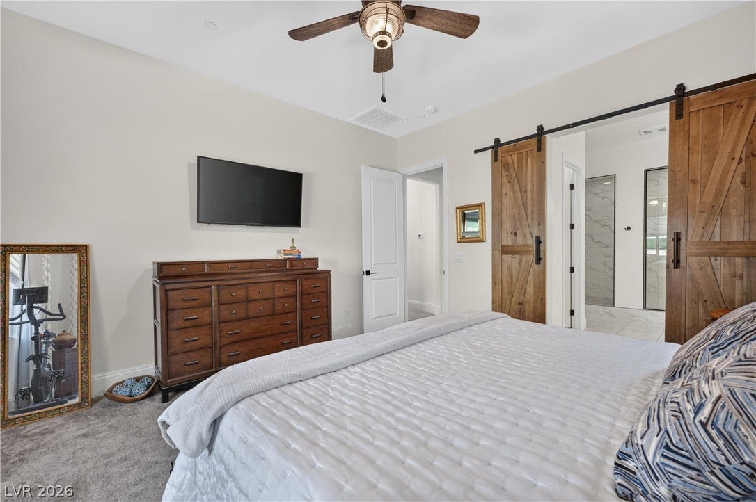 4 Bobado Lane, Henderson, NV 89011 Double sliding barn doors open directly into a private bathroom suite.