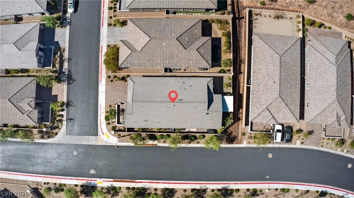4 Bobado Lane, Henderson, NV 89011 An aerial perspective captures the tiled roofline and surrounding neighborhood streets from directly overhead.