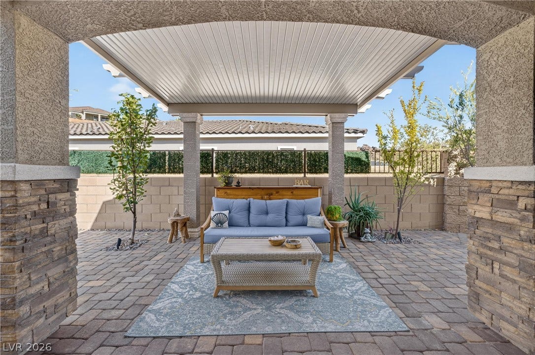4 Bobado Lane, Henderson, NV 89011 A stone-accented archway opens to a covered patio paved with classic stone pavers.