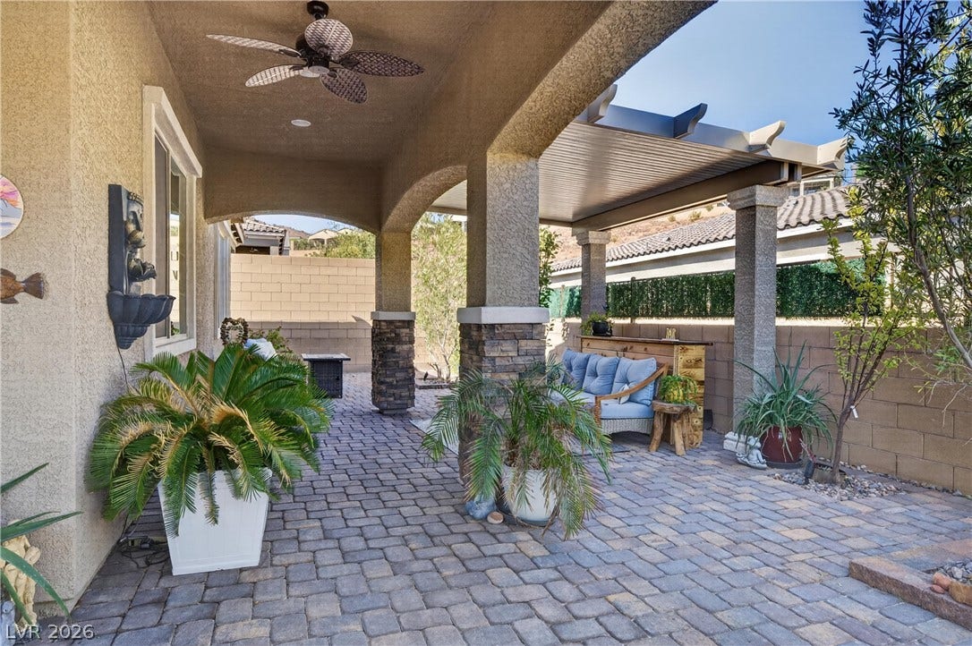 4 Bobado Lane, Henderson, NV 89011 Stone pillars and brick pavers highlight this inviting covered patio space.