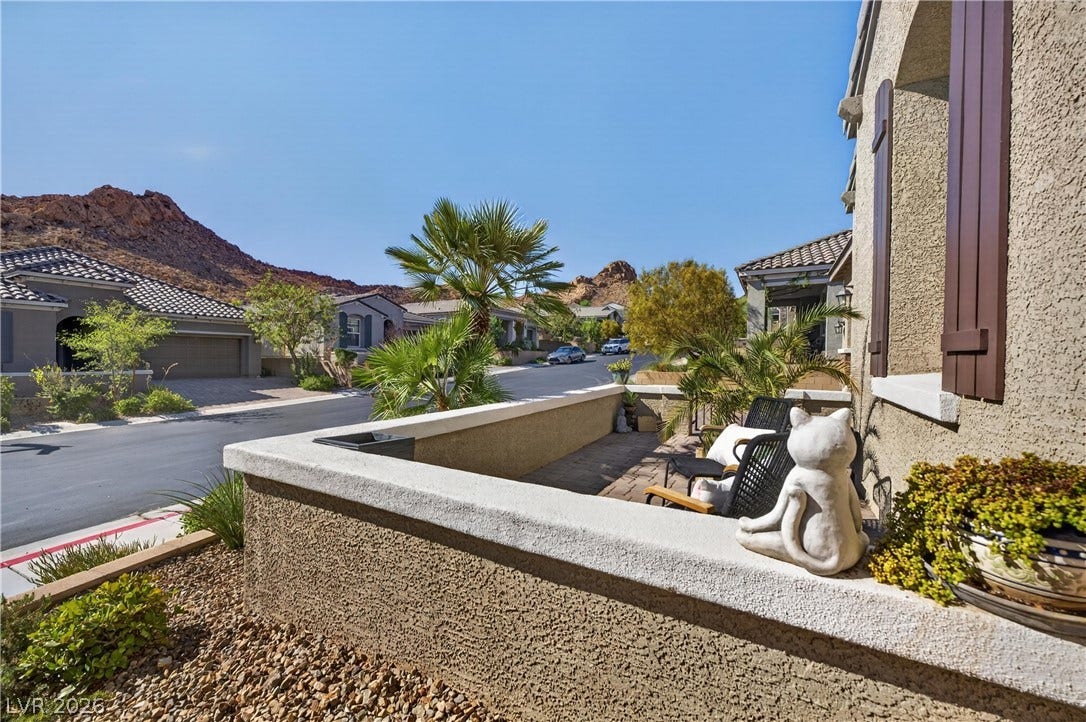 4 Bobado Lane, Henderson, NV 89011 An inviting front patio overlooks the quiet neighborhood street framed by scenic mountain backdrops.