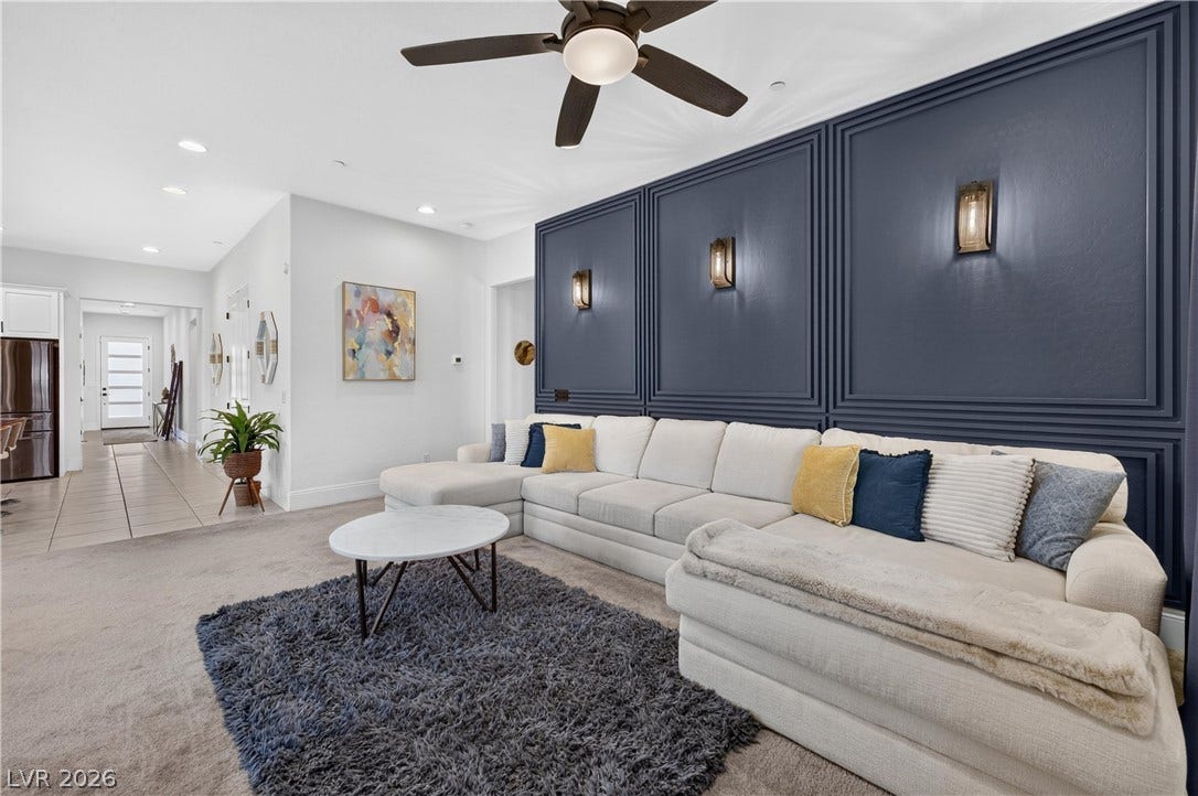 4 Bobado Lane, Henderson, NV 89011 Elegant wall molding and recessed lighting elevate this spacious, open-concept living area.