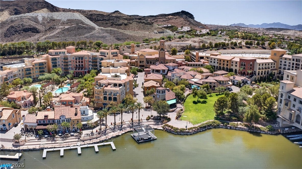 4 Bobado Lane, Henderson, NV 89011 A picturesque lakeside village rests beneath rugged desert mountains.