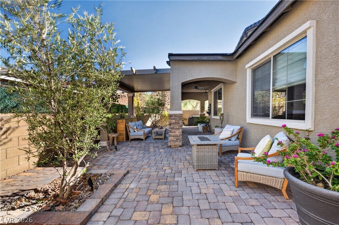 4 Bobado Lane, Henderson, NV 89011 An inviting stone paver patio offers a covered retreat alongside a landscaped side yard.