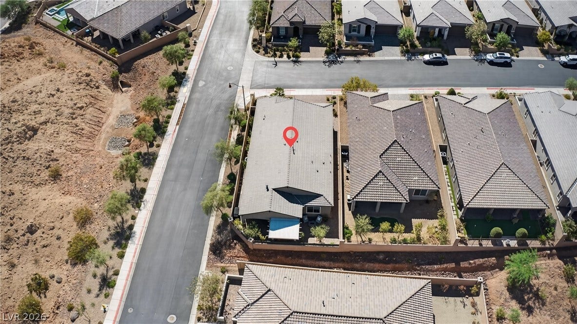 4 Bobado Lane, Henderson, NV 89011 An aerial perspective showcases the classic tile roofing and structured suburban neighborhood layout.