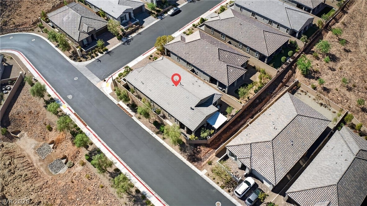 4 Bobado Lane, Henderson, NV 89011 An aerial perspective captures modern tile roofs nestled in a quiet suburban neighborhood.