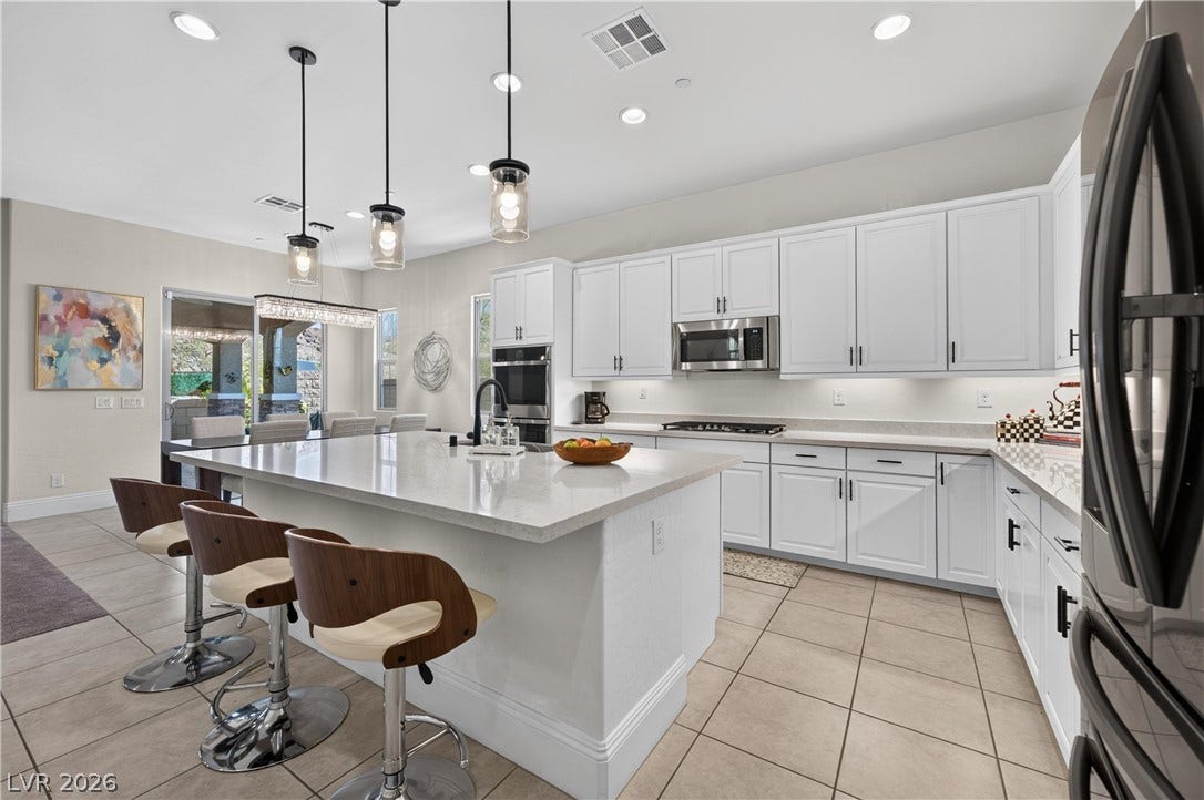 4 Bobado Lane, Henderson, NV 89011 An expansive central island highlights this culinary space featuring recessed lighting and tile flooring.