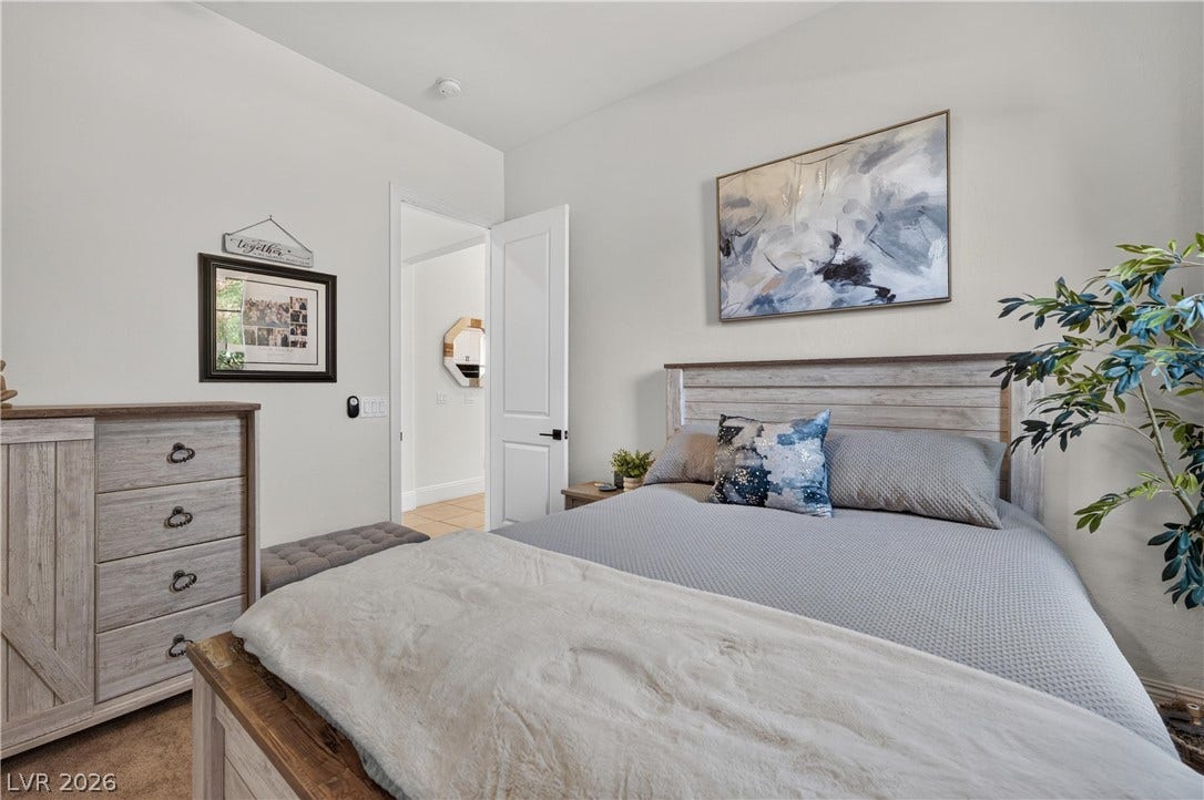 4 Bobado Lane, Henderson, NV 89011 Smooth plaster walls and neutral carpeting create a serene atmosphere in this cozy bedroom.