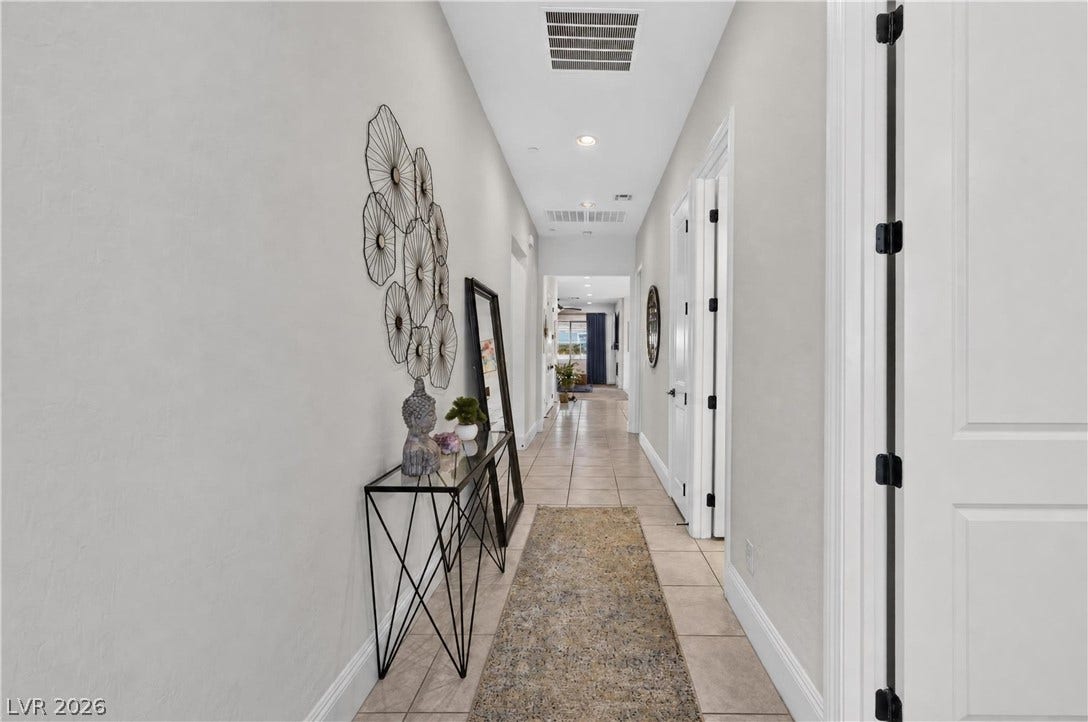 4 Bobado Lane, Henderson, NV 89011 Tiled flooring and recessed lighting define this long, inviting hallway layout.