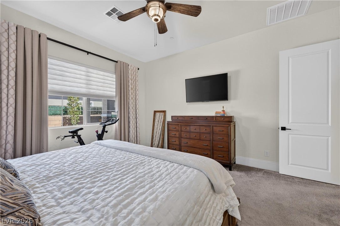 4 Bobado Lane, Henderson, NV 89011 An abundance of natural light fills this bedroom complete with plush carpeting and high ceilings.
