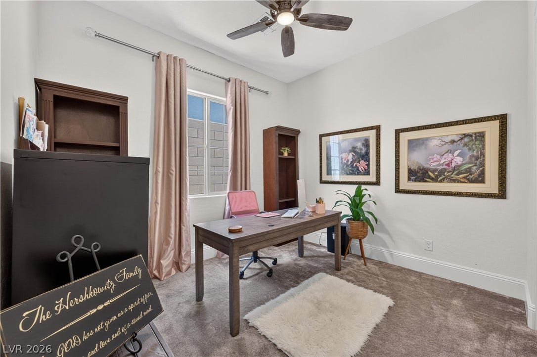 4 Bobado Lane, Henderson, NV 89011 High ceilings and neutral-toned carpeting define this versatile home workspace.