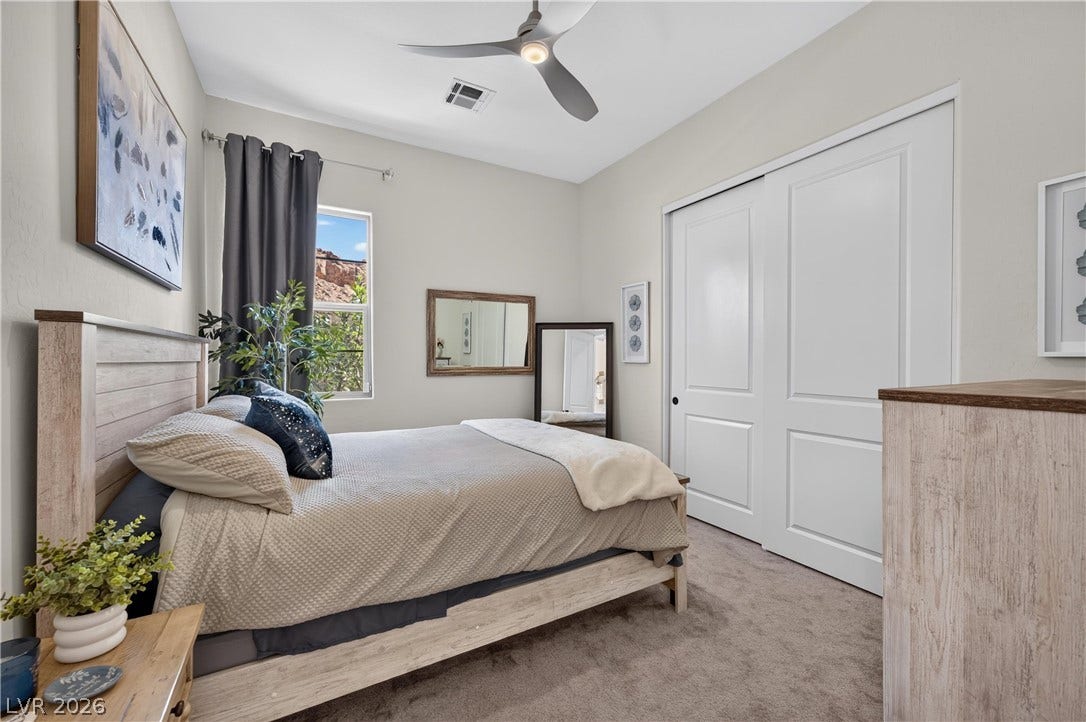 4 Bobado Lane, Henderson, NV 89011 Soft carpeting pairs with crisp sliding closet doors in this serene bedroom space.