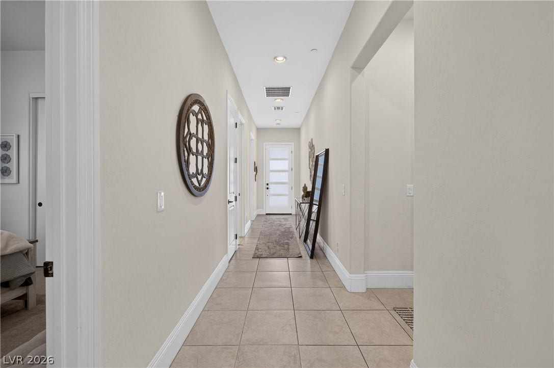 4 Bobado Lane, Henderson, NV 89011 An inviting hallway showcases neutral tile flooring and clean architectural lines.