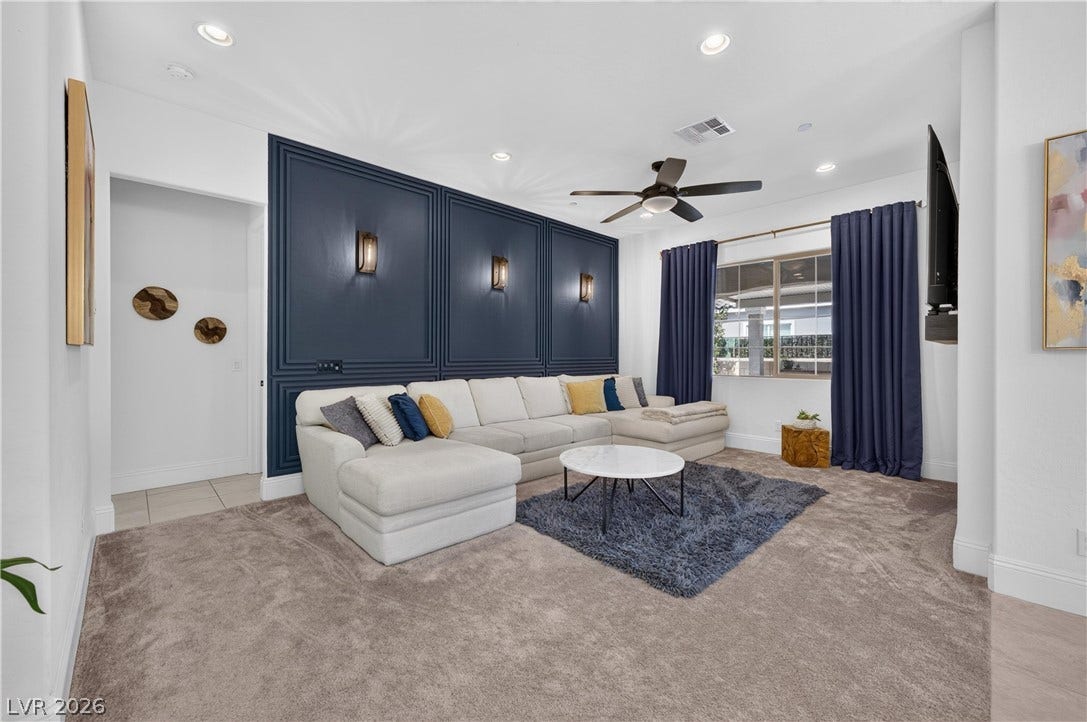 4 Bobado Lane, Henderson, NV 89011 Sophisticated paneling anchors a comfortable living area illuminated by recessed lighting.