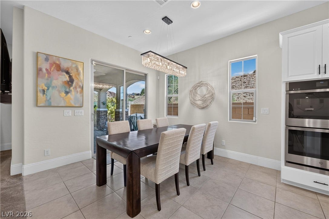 4 Bobado Lane, Henderson, NV 89011 Tile flooring and sliding glass doors define this elegant dining space open to the kitchen.