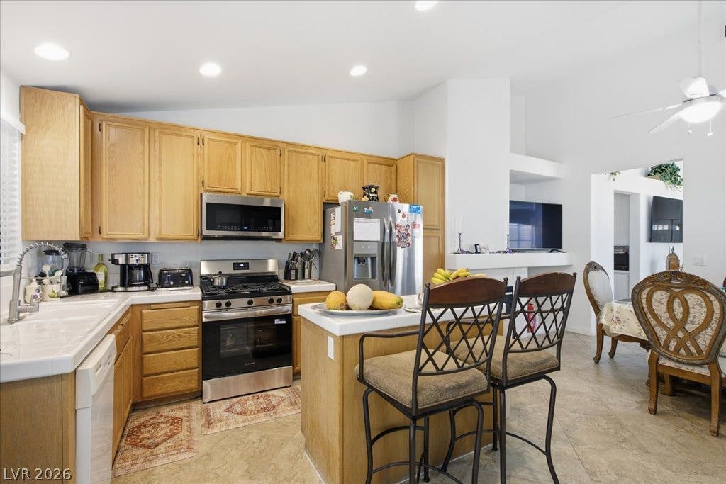 Ample wooden cabinetry and an efficient island highlight this central cooking area.
