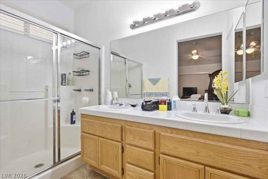 A spacious double vanity and enclosed walk-in shower highlight this functional primary bathroom layout.