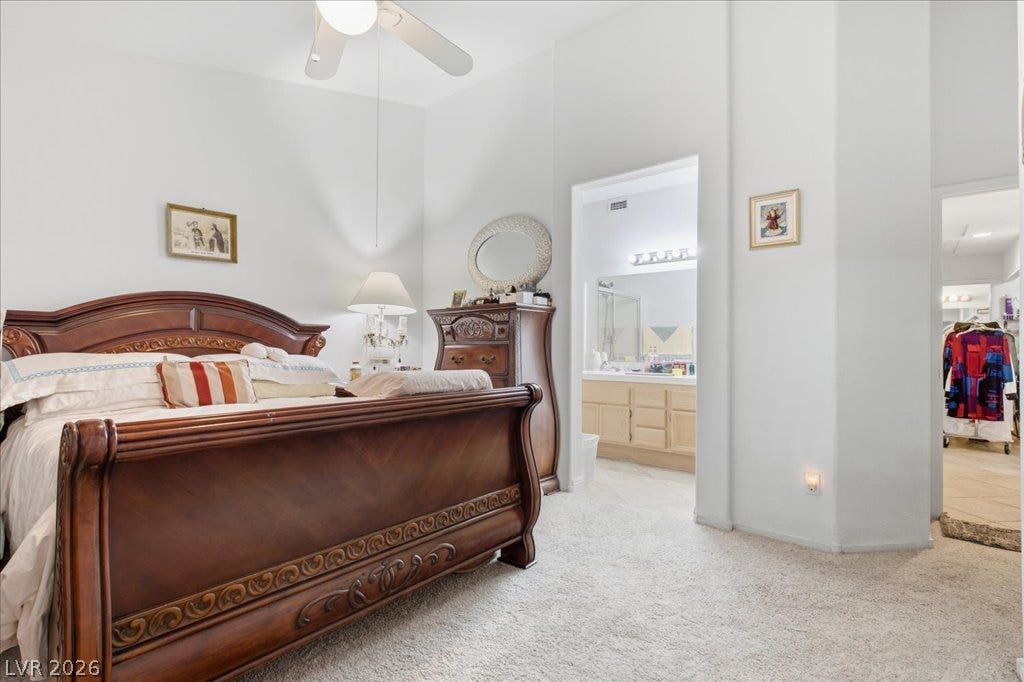 High ceilings and soft carpeting define this tranquil bedroom suite.