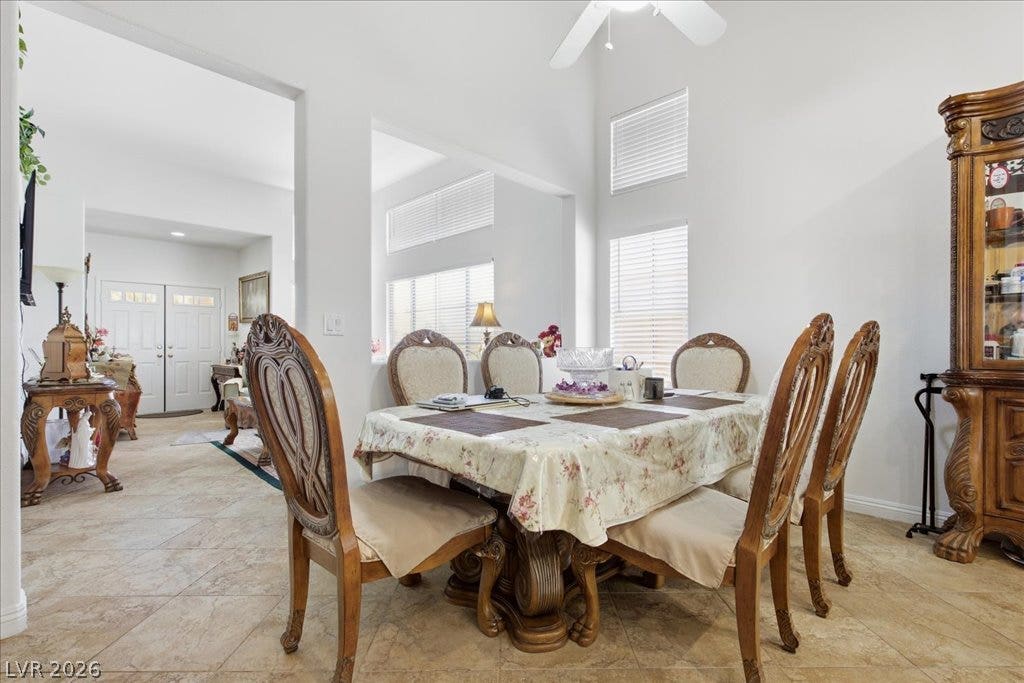 High ceilings and neutral tile flooring define this airy dining space.