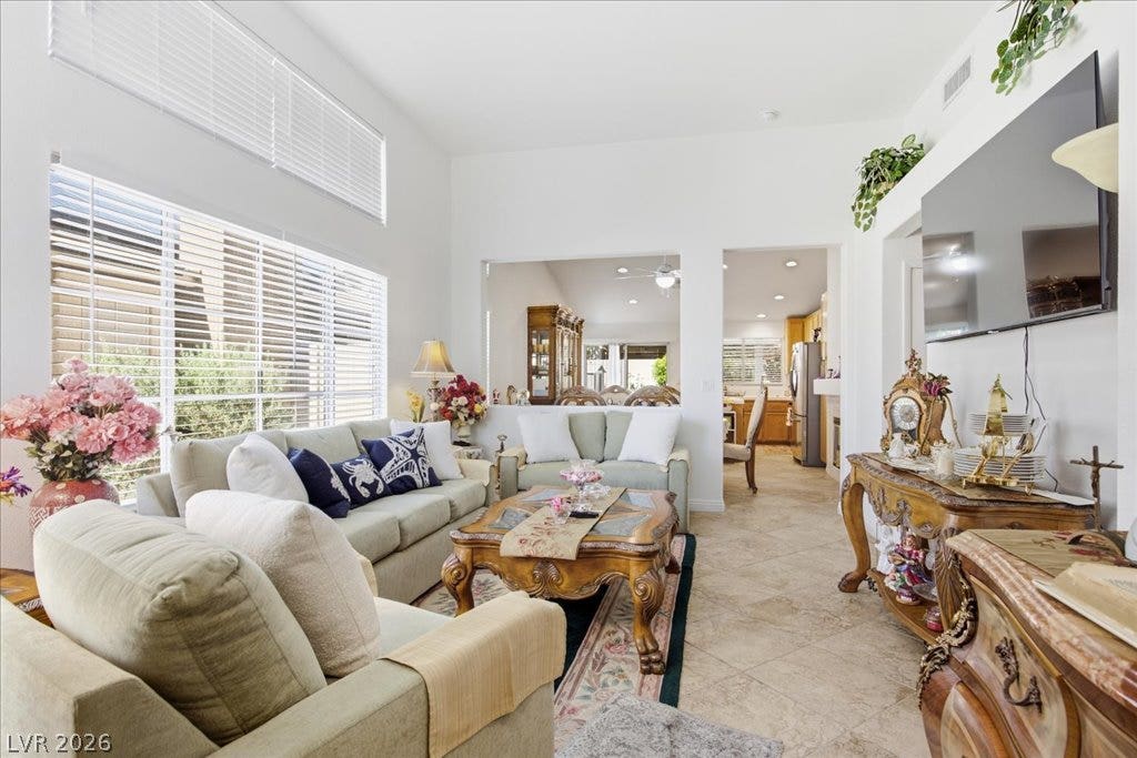 High ceilings and generous windows elevate this tile-floored living space.