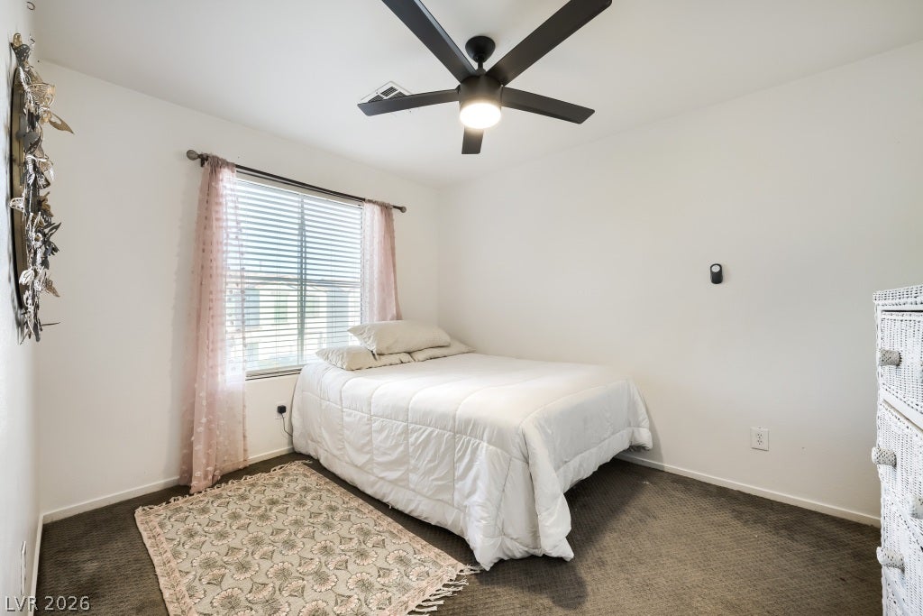 2099 Lost Maple Street, Las Vegas, NV 89115 A well-proportioned bedroom showcases classic carpeting and a window allowing in abundant natural light.
