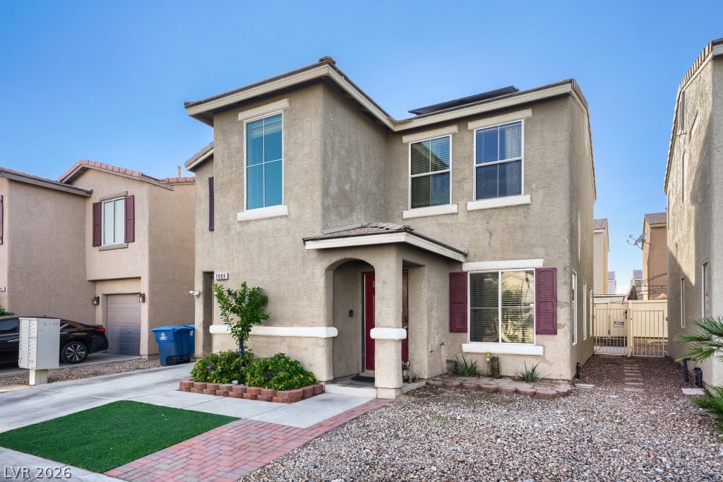2099 Lost Maple Street, Las Vegas, NV 89115 A classic two-story stucco exterior stands out against a clear blue desert sky.
