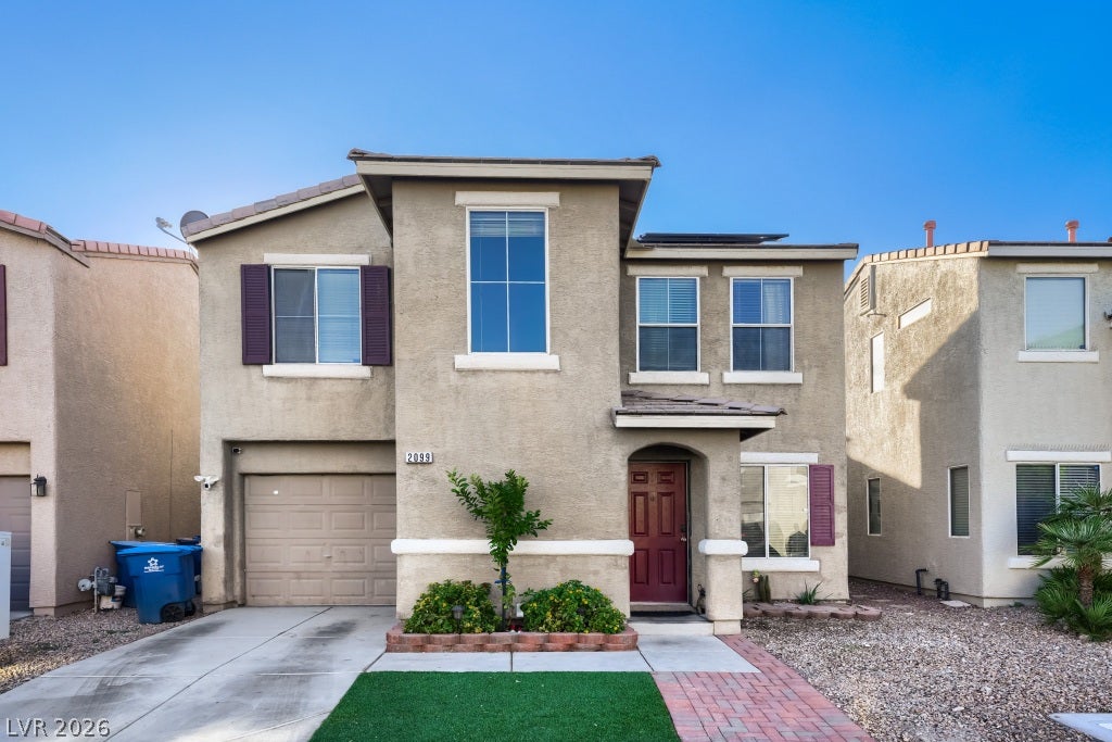 2099 Lost Maple Street, Las Vegas, NV 89115 Classic stucco architecture frames this multi-level exterior featuring clean geometric lines and a paved walkway.