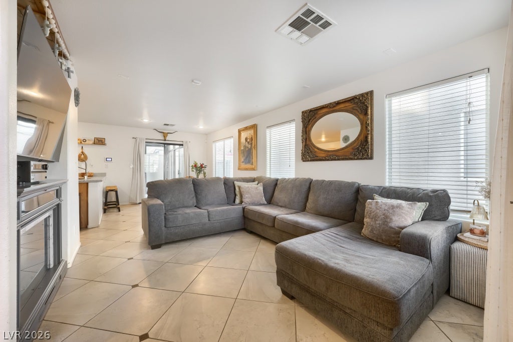 2099 Lost Maple Street, Las Vegas, NV 89115 Diagonal floor tiles and classic crown molding accent this comfortable living space.