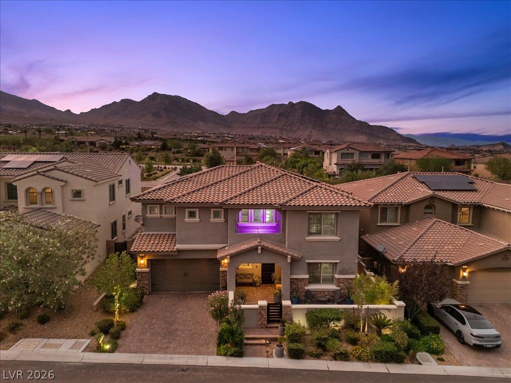 181 Elder View Drive, Las Vegas, NV 89138 Dramatic mountain backdrops frame this elegant multi-level residence with a beautifully tiled roof.