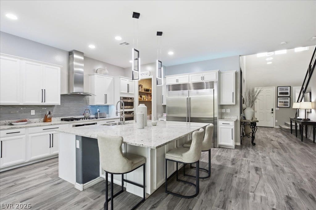 181 Elder View Drive, Las Vegas, NV 89138 Culinary excellence awaits in this modern kitchen featuring a vast island with bar seating and premium appliances.