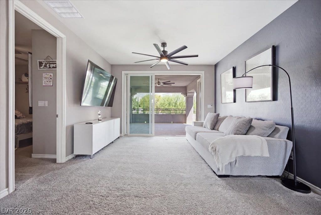 181 Elder View Drive, Las Vegas, NV 89138 Sliding glass doors connect the comfortable living area to a spacious outdoor patio.