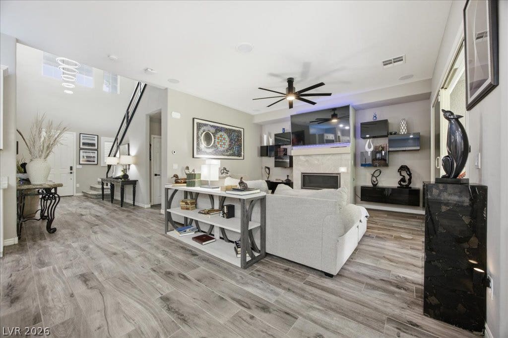 181 Elder View Drive, Las Vegas, NV 89138 Gleaming wood-look tile floors and a soaring ceiling define this open-concept main living area.