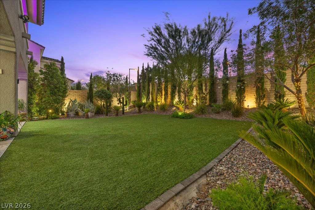 181 Elder View Drive, Las Vegas, NV 89138 Lush manicured turf and professional uplighting define this private, fully walled rear yard.