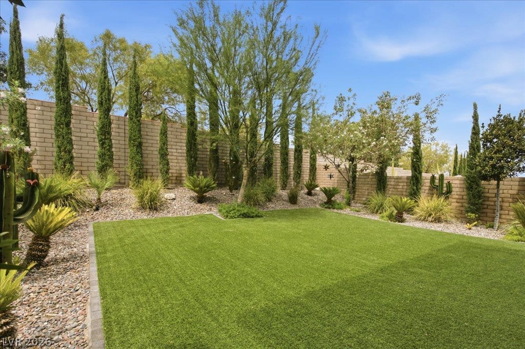 181 Elder View Drive, Las Vegas, NV 89138 A neatly manicured lawn with mature landscaping creates a tranquil backyard retreat.