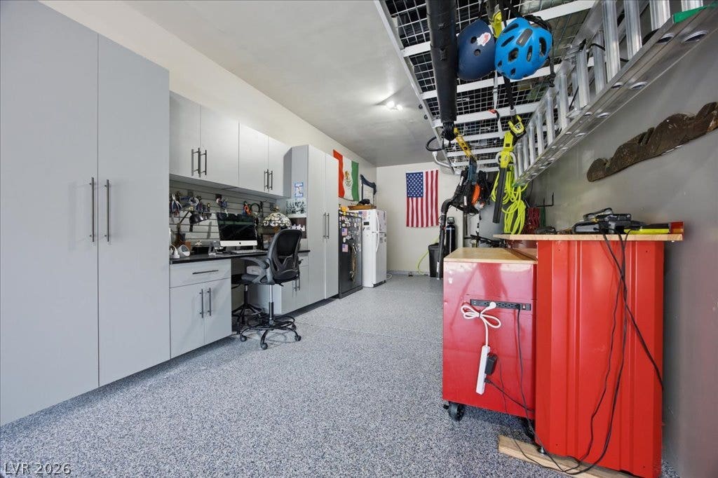 181 Elder View Drive, Las Vegas, NV 89138 An organized garage space features custom cabinetry, integrated workspace, and durable epoxy flooring.