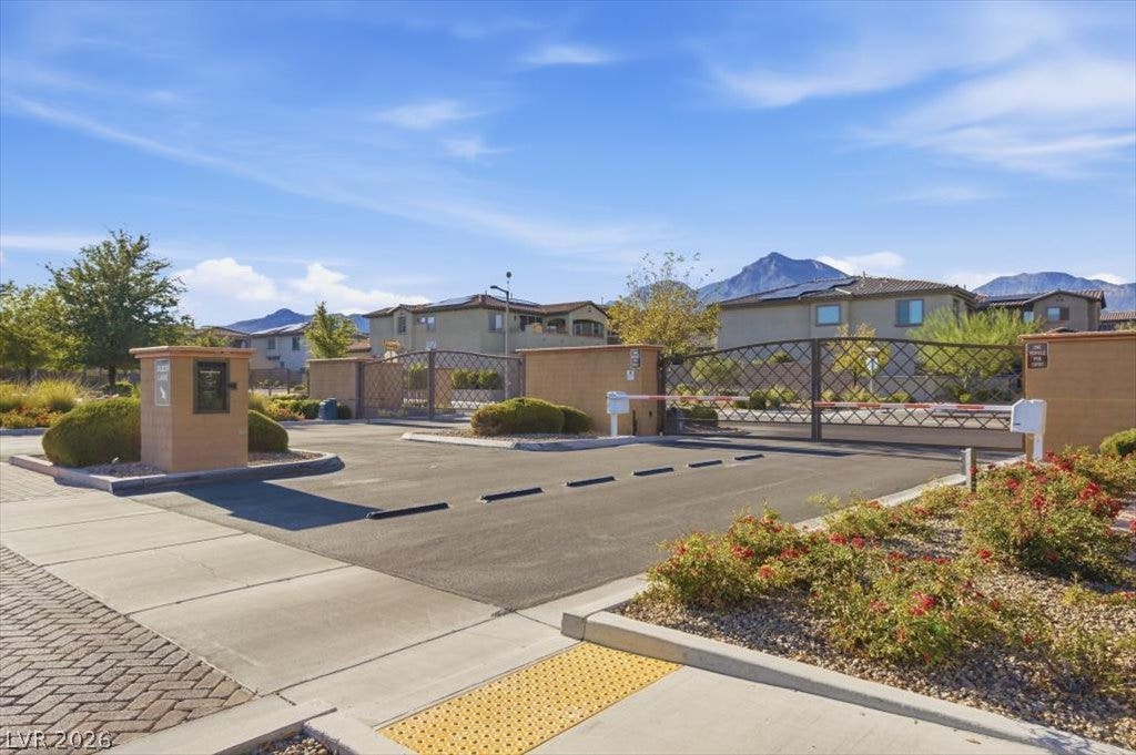 181 Elder View Drive, Las Vegas, NV 89138 A secure gated entrance stands before a peaceful neighborhood framed by mountain views.