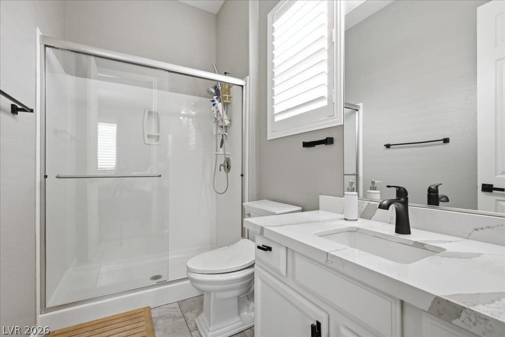 181 Elder View Drive, Las Vegas, NV 89138 A well-appointed bath features a spacious glass-enclosed shower alongside a contemporary vanity with a sleek black faucet.