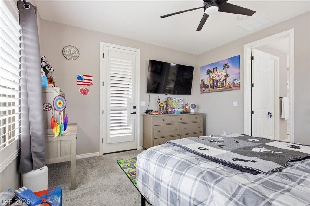 181 Elder View Drive, Las Vegas, NV 89138 A comfortable bedroom features carpet flooring and a ceiling fan for optimal air circulation.