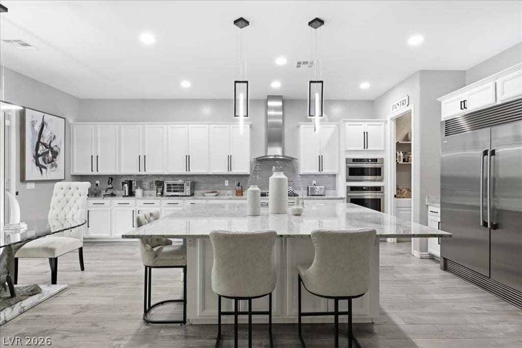 181 Elder View Drive, Las Vegas, NV 89138 A culinary dream with polished light-colored flooring and sleek stainless steel appliances, creating an inviting space for entertaining.