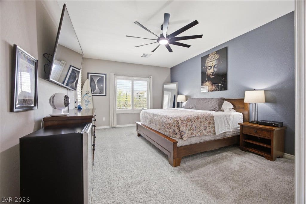 181 Elder View Drive, Las Vegas, NV 89138 A spacious bedroom showcases plush carpeting and a large window looking out to the neighborhood.